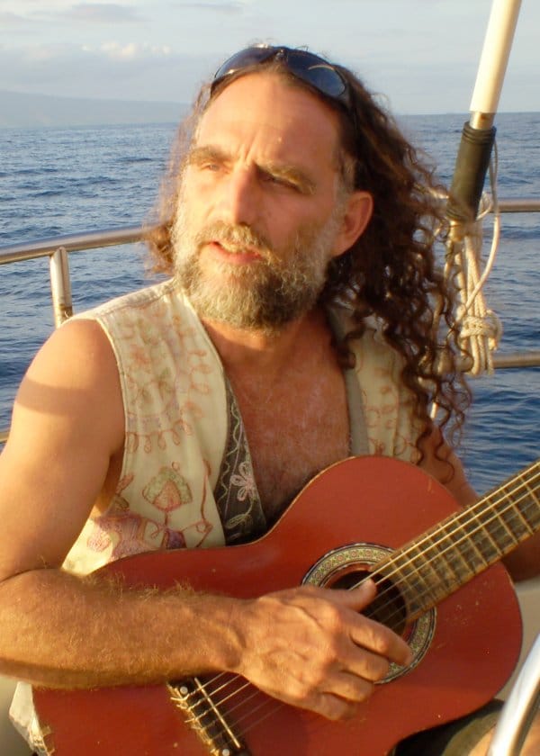 Shiner Bruce Whitaker with his guitar off the coast of Maui
